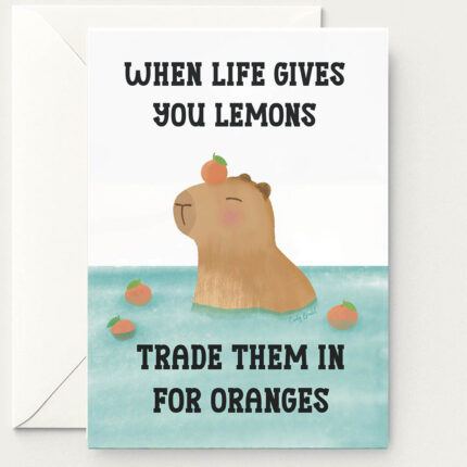 Encouragement greeting card featuring a capybara in water surrounded by oranges. The text says when life gives you lemons, treat them in for oranges.